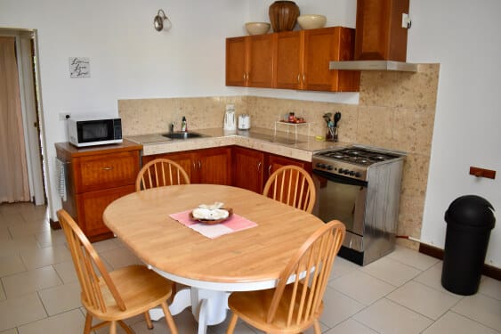 modern kitchen with dining area, stove, oven and microwave